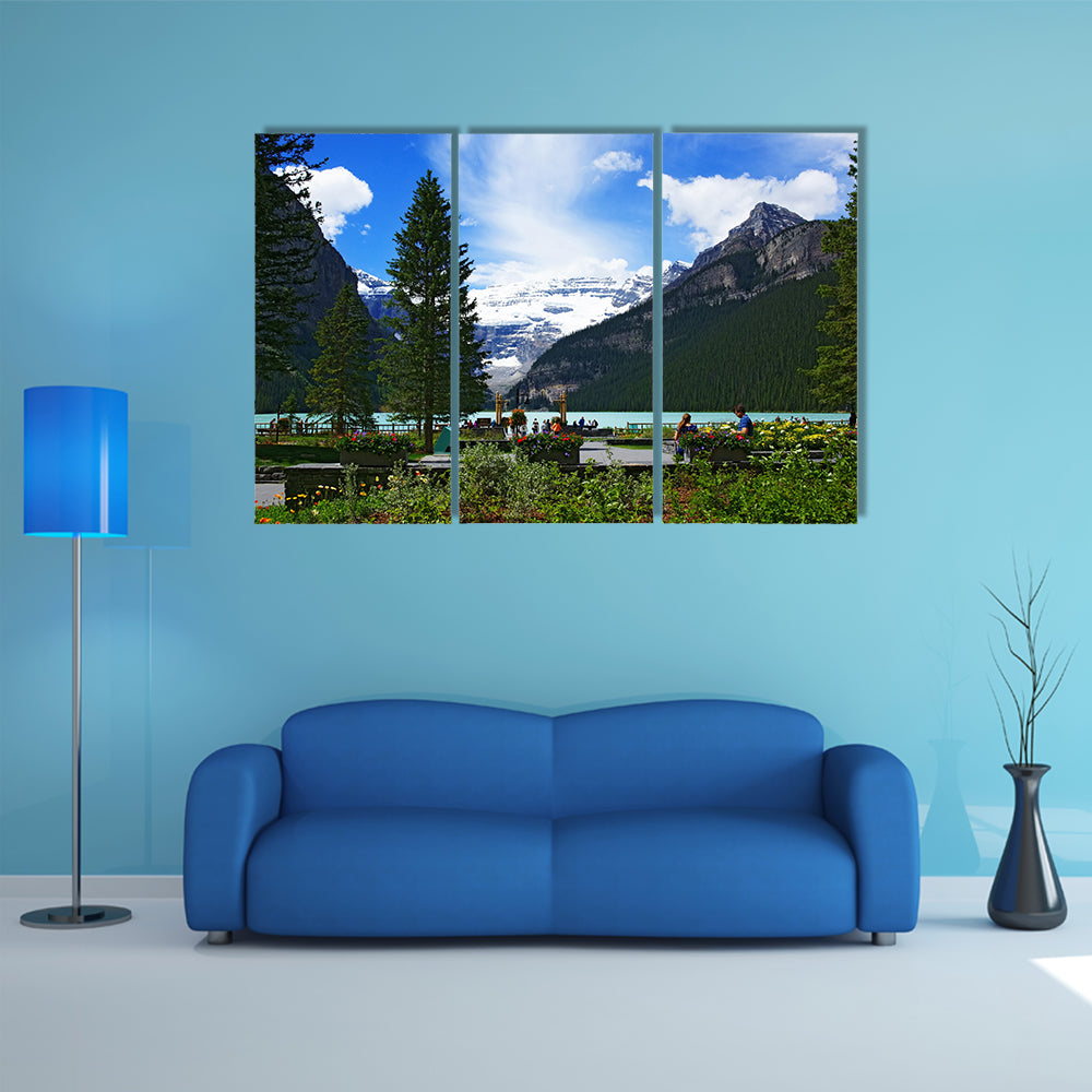 People chilling out and dating in front of Lake Louise, seen from the Fairmont Chateau Lake Louise hotel multi panel canvas wall art