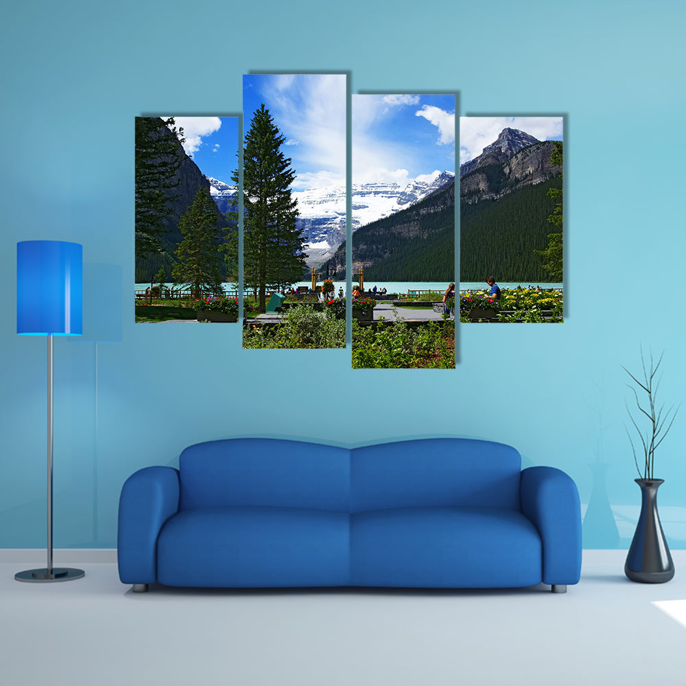 People chilling out and dating in front of Lake Louise, seen from the Fairmont Chateau Lake Louise hotel multi panel canvas wall art