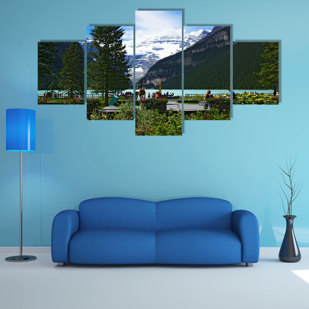 People chilling out and dating in front of Lake Louise, seen from the Fairmont Chateau Lake Louise hotel multi panel canvas wall art