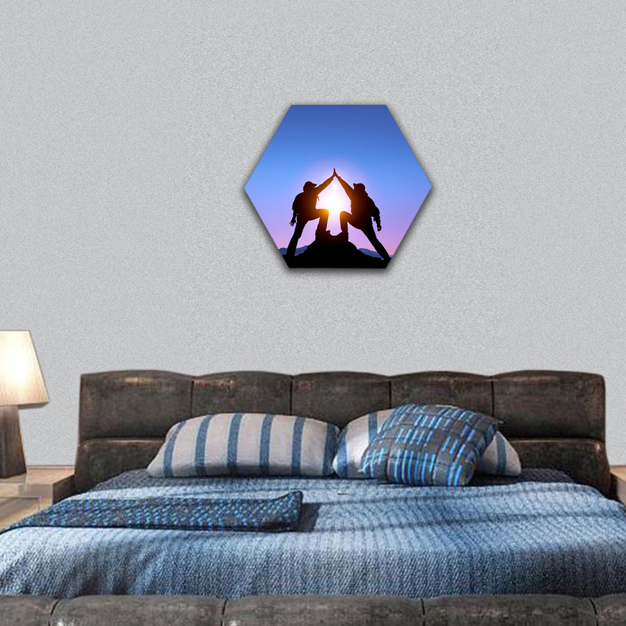 Silhouette of two man on the top of mountain hexagonal canvas wall art