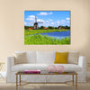 Traditional Dutch windmills along a canal near Alkmaar, Netherlands Multi panel canvas wall art