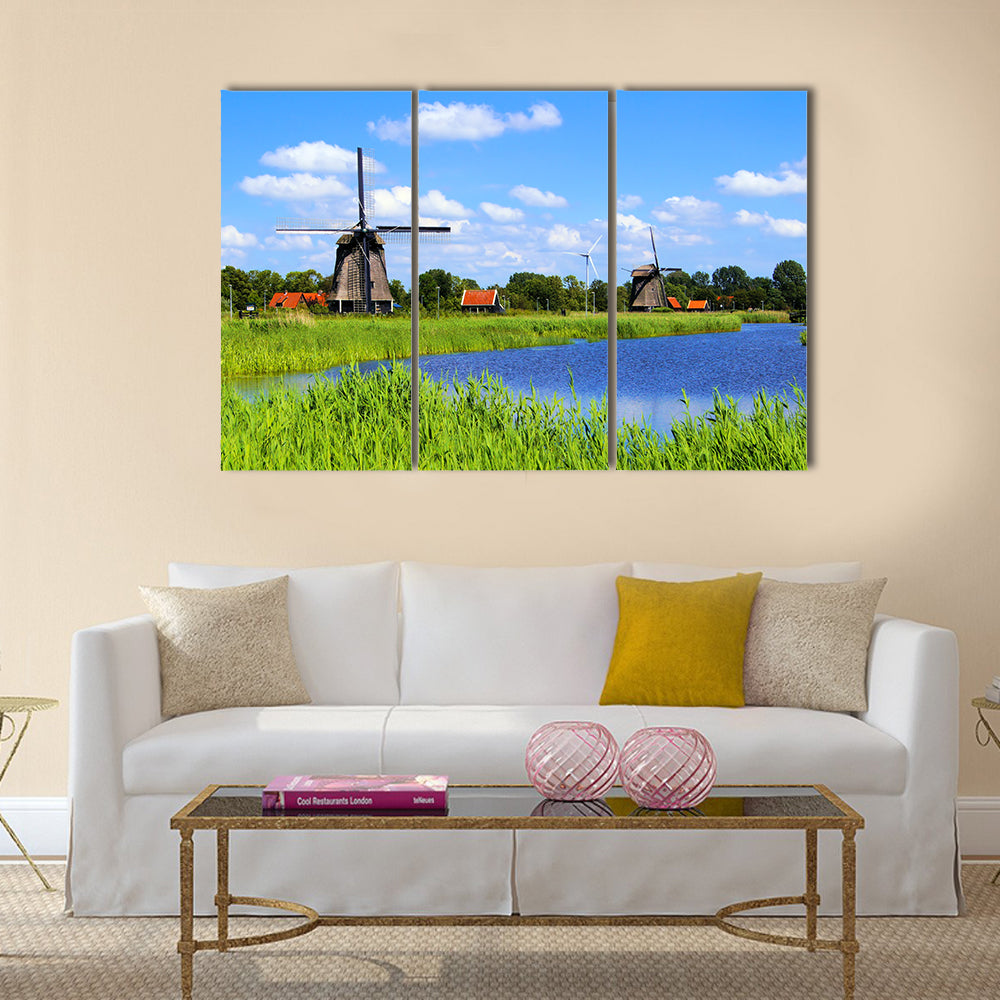 Traditional Dutch windmills along a canal near Alkmaar, Netherlands Multi panel canvas wall art