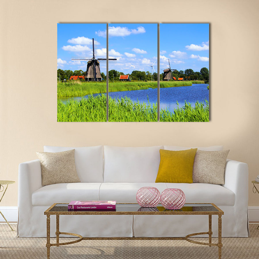 Traditional Dutch windmills along a canal near Alkmaar, Netherlands Multi panel canvas wall art