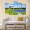 Traditional Dutch windmills along a canal near Alkmaar, Netherlands Multi panel canvas wall art