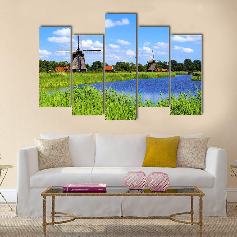 Traditional Dutch windmills along a canal near Alkmaar, Netherlands Multi panel canvas wall art