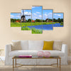 Traditional Dutch windmills along a canal near Alkmaar, Netherlands Multi panel canvas wall art