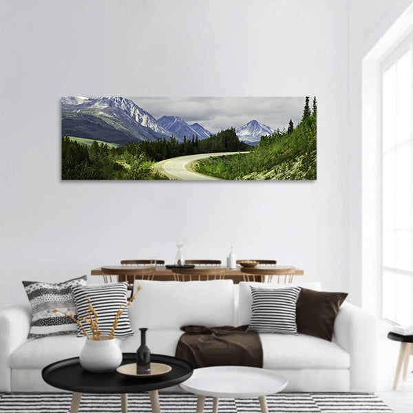Curved asphalt road in high mountains of Alaska panoramic canvas wall art