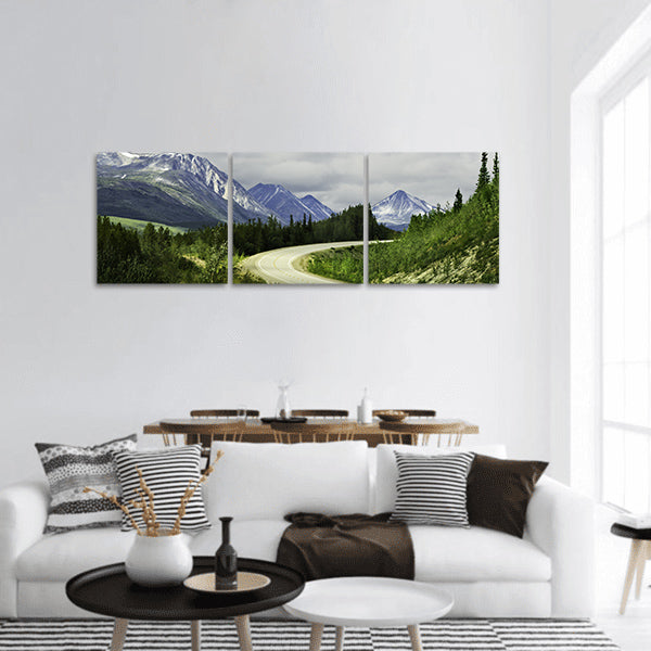 Curved asphalt road in high mountains of Alaska panoramic canvas wall art