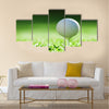 Golf ball on green grass Multi Panel Canvas Wall Art