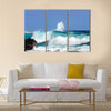 Waves are high and this one curls and rolls over the black rocks of Ahalanui Beach on the Big Island of Hawaii Multi Panel Canvas Wall Art