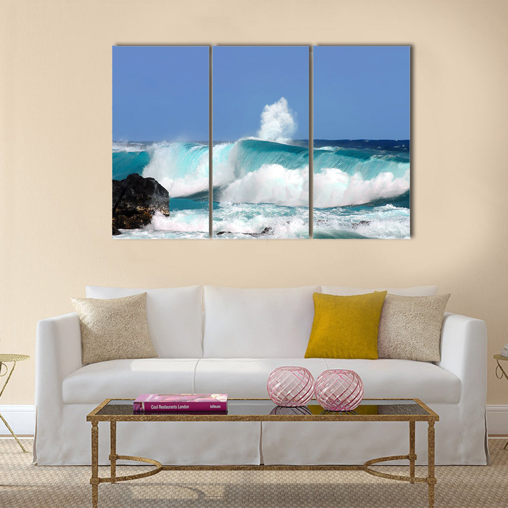 Waves are high and this one curls and rolls over the black rocks of Ahalanui Beach on the Big Island of Hawaii Multi Panel Canvas Wall Art