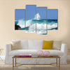 Waves are high and this one curls and rolls over the black rocks of Ahalanui Beach on the Big Island of Hawaii Multi Panel Canvas Wall Art