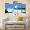 Waves are high and this one curls and rolls over the black rocks of Ahalanui Beach on the Big Island of Hawaii Multi Panel Canvas Wall Art