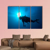 Silhouette of diver with sun disk behind Multi panel canvas wall art