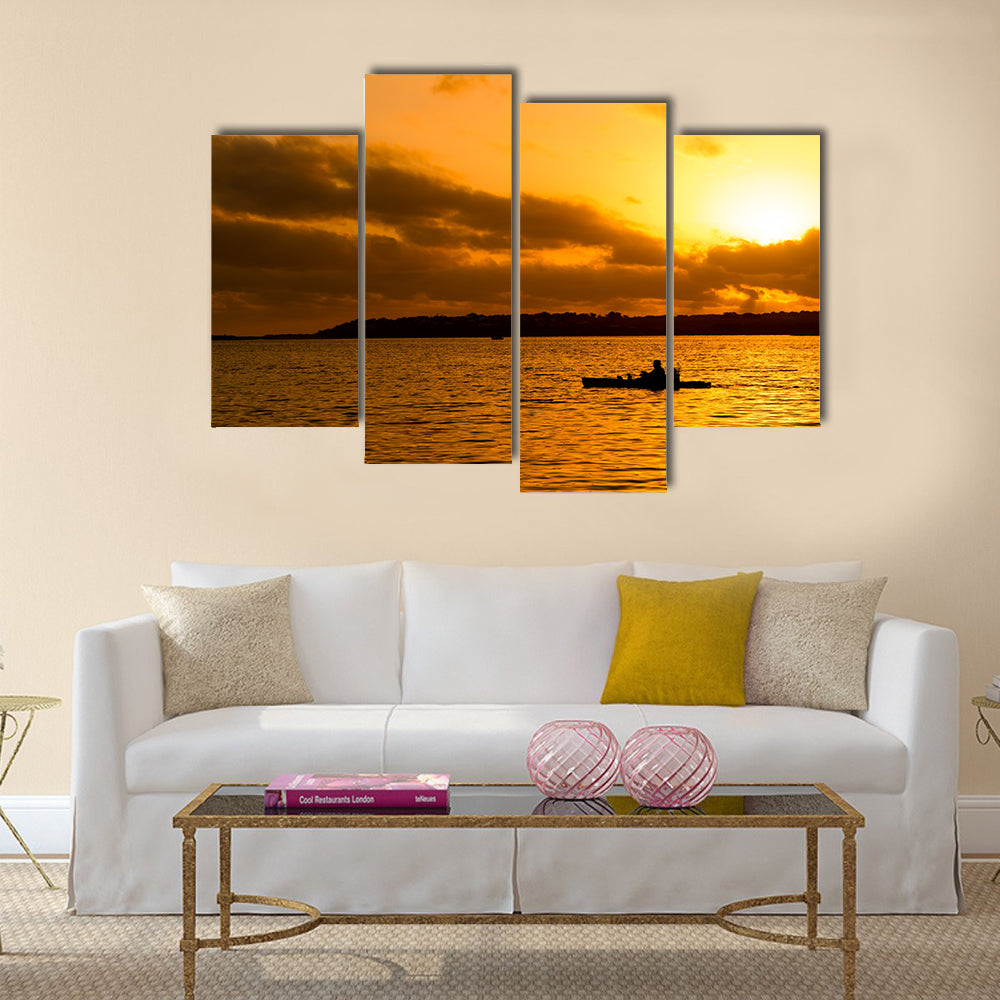 Fisherman silhouette in kayak Multi panel canvas wall art