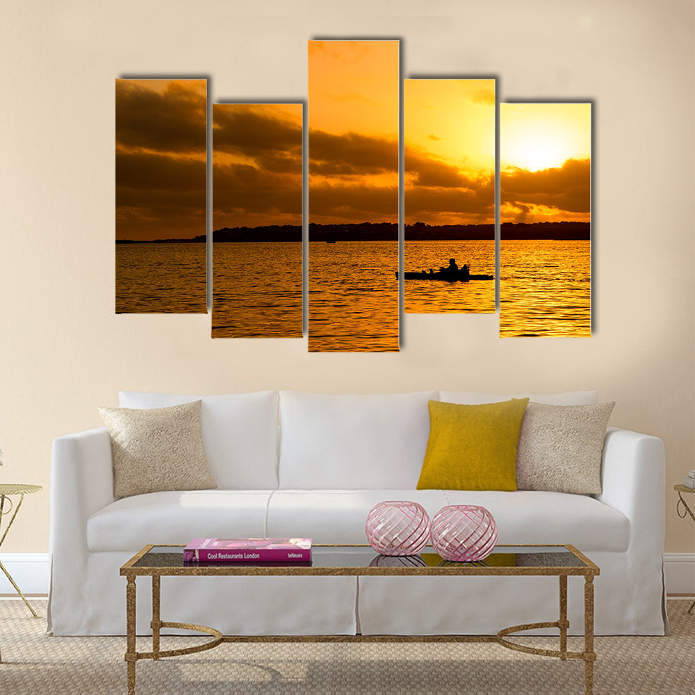 Fisherman silhouette in kayak Multi panel canvas wall art