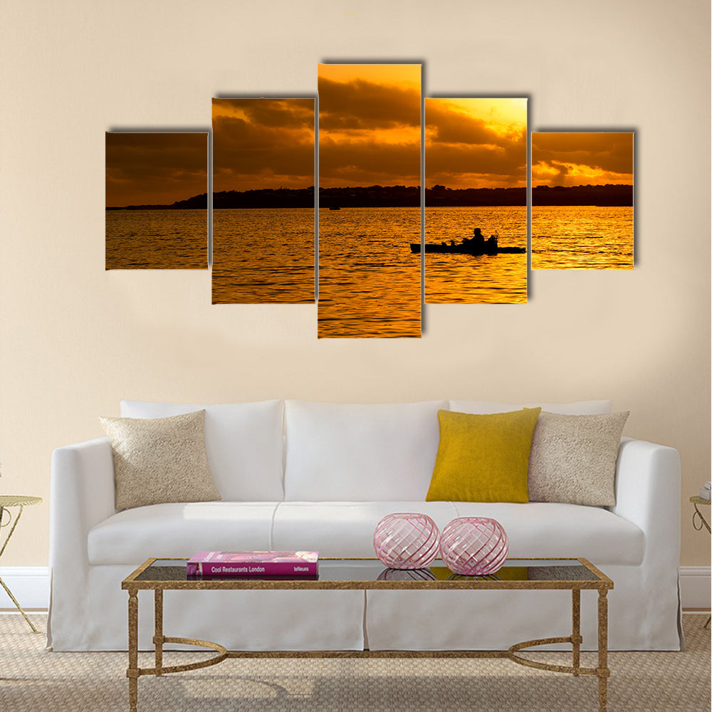 Fisherman silhouette in kayak Multi panel canvas wall art