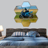 A motorbike speed on the street hexagonal canvas wall art