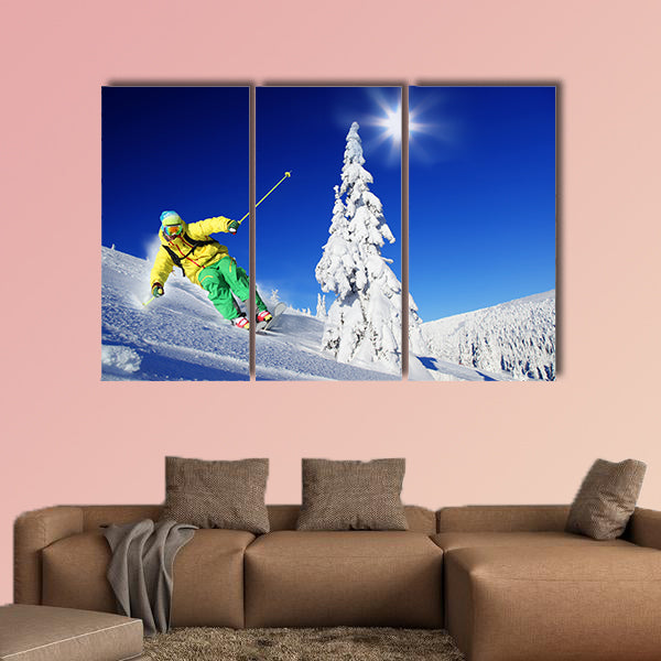 Skier skiing downhill in high mountains Multi panel canvas wall art