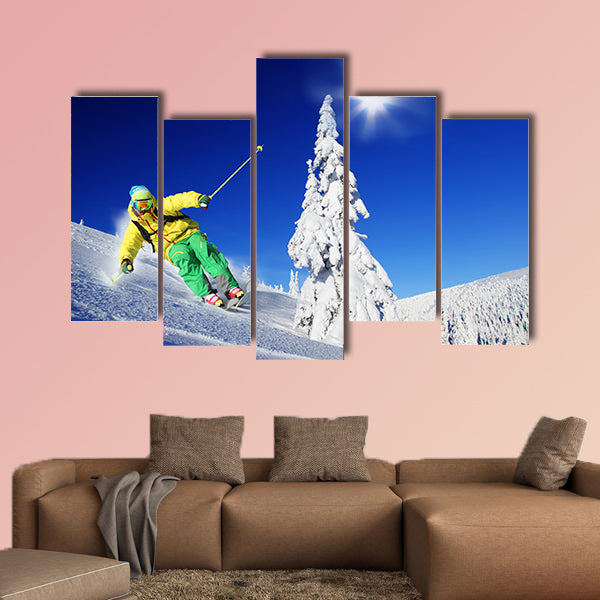 Skier skiing downhill in high mountains Multi panel canvas wall art