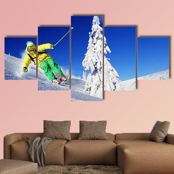 Skier skiing downhill in high mountains Multi panel canvas wall art