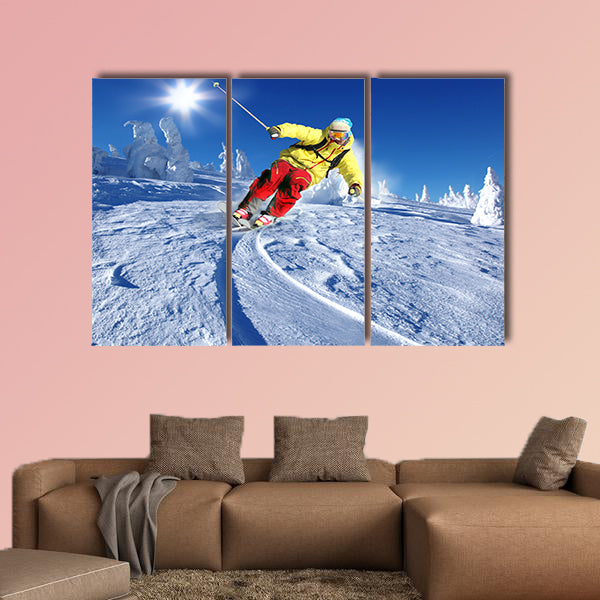 Skier skiing downhill in high mountains Multi panel canvas wall art