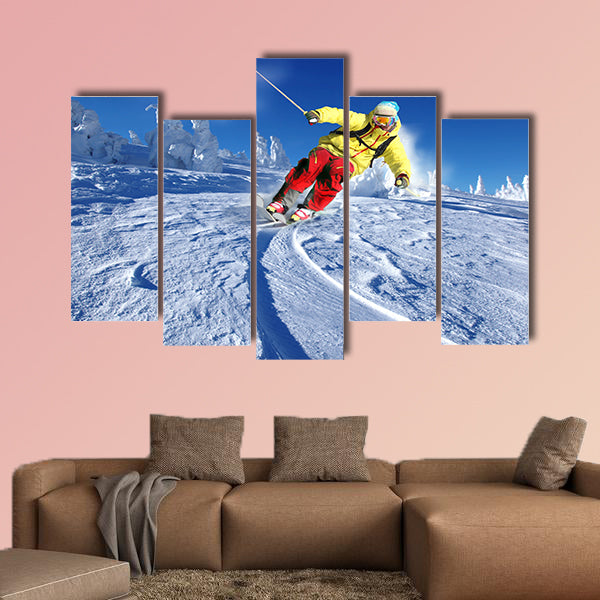 Skier skiing downhill in high mountains Multi panel canvas wall art