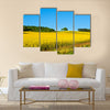 Rapeseed field with forest far away Multi panel canvas wall art