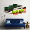 Close up view of tennis racket and balls on the clay tennis court Multi panel canvas wall art