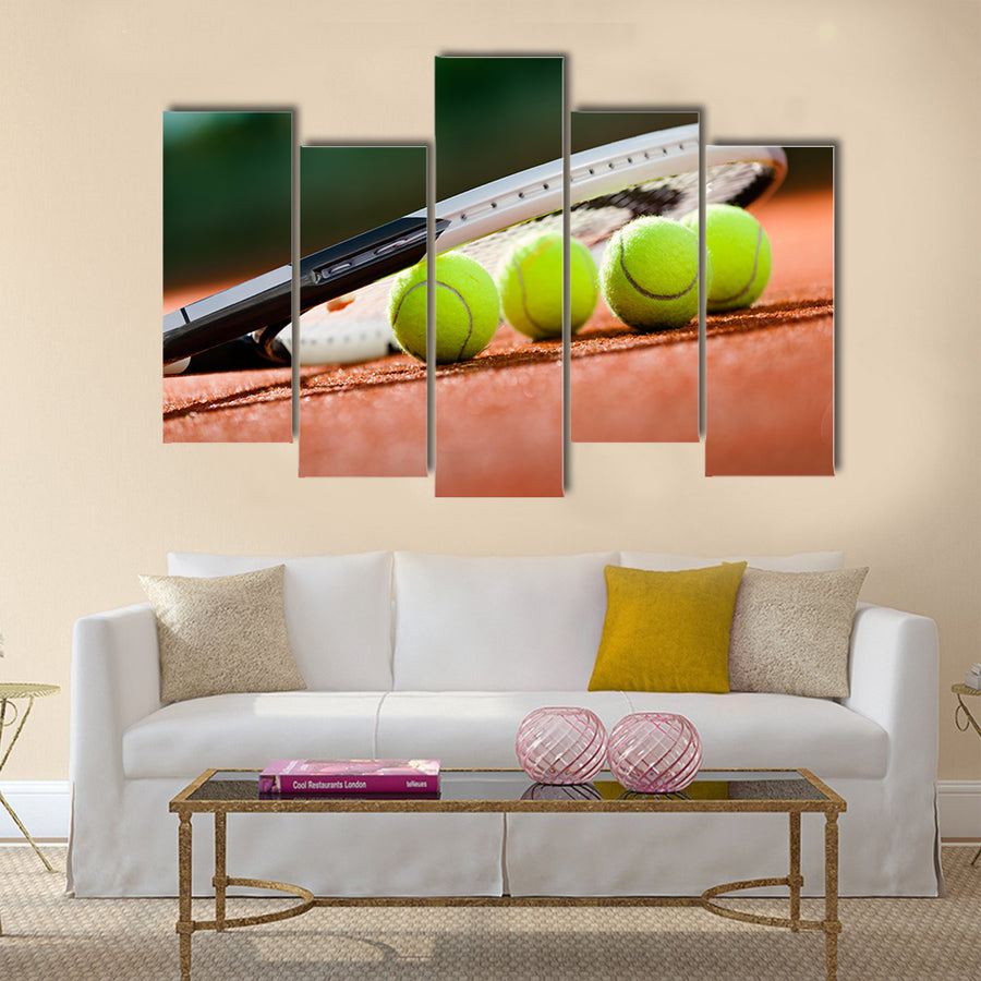 Close up view of tennis racket and balls on the clay tennis court Multi panel canvas wall art