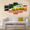 Close up view of tennis racket and balls on the clay tennis court Multi panel canvas wall art