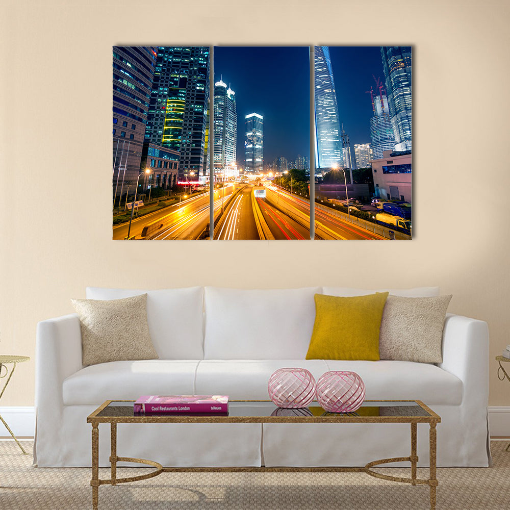 Light trails on the street with modern building background multi panel canvas wall art
