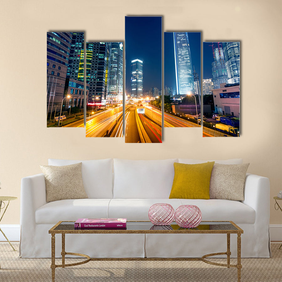 Light trails on the street with modern building background multi panel canvas wall art