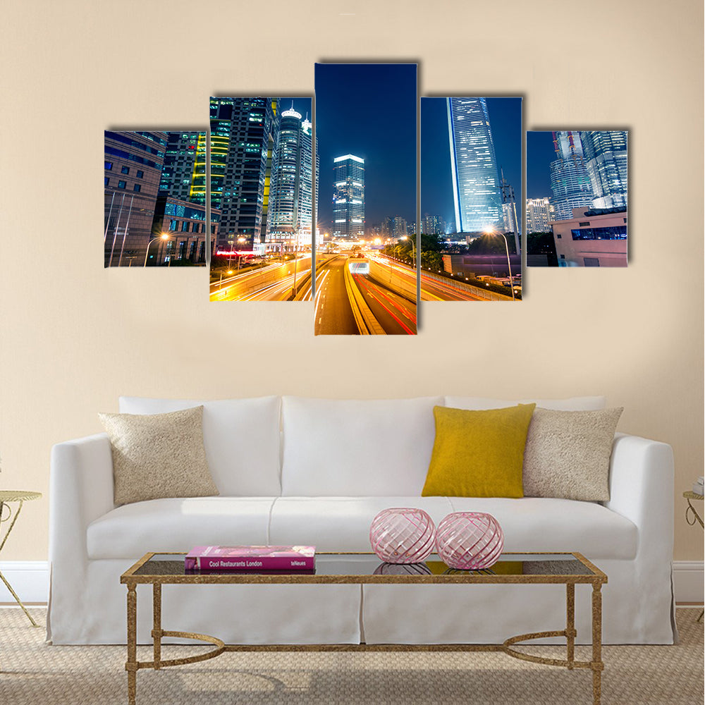 Light trails on the street with modern building background multi panel canvas wall art