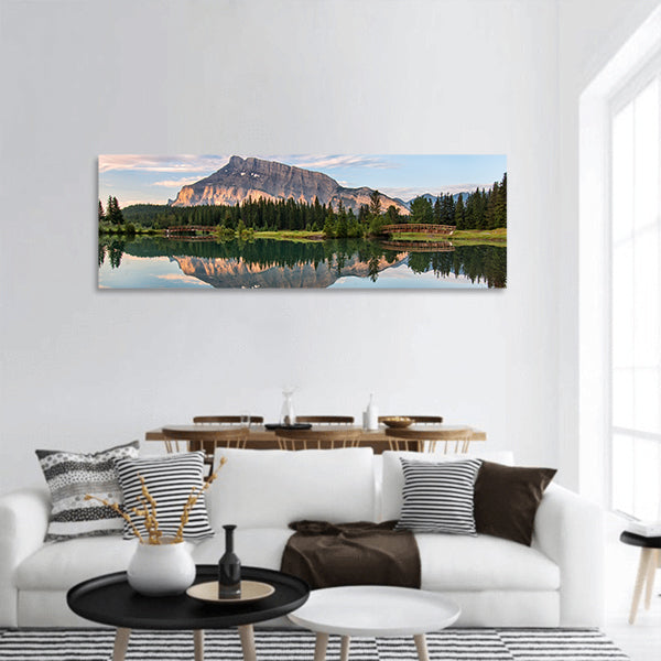 Rundle mountain reflected in pond with two bridges panoramic canvas wall art