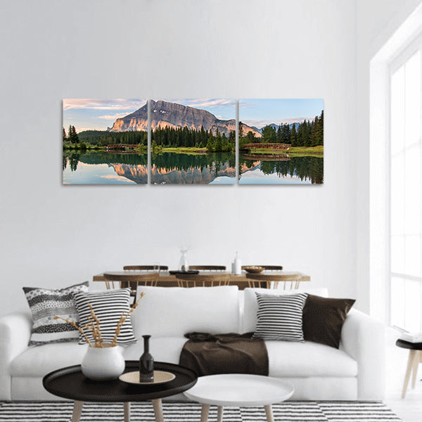 Rundle mountain reflected in pond with two bridges panoramic canvas wall art
