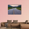 Winding road that leads to beautiful sunset lit mountains wall art