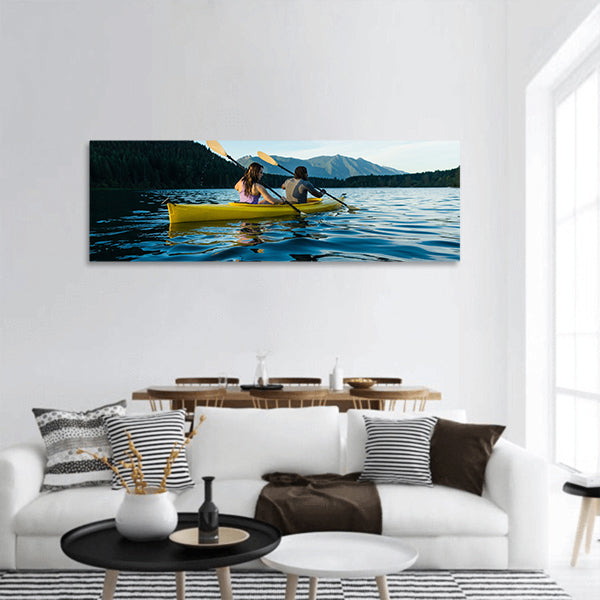 Couple paddling in kayak on lake panoramic canvas wall art