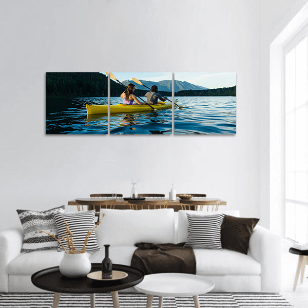 Couple paddling in kayak on lake panoramic canvas wall art