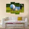 Golf ball on tee in front of driver on a gold course Multi Panel Canvas Wall Art