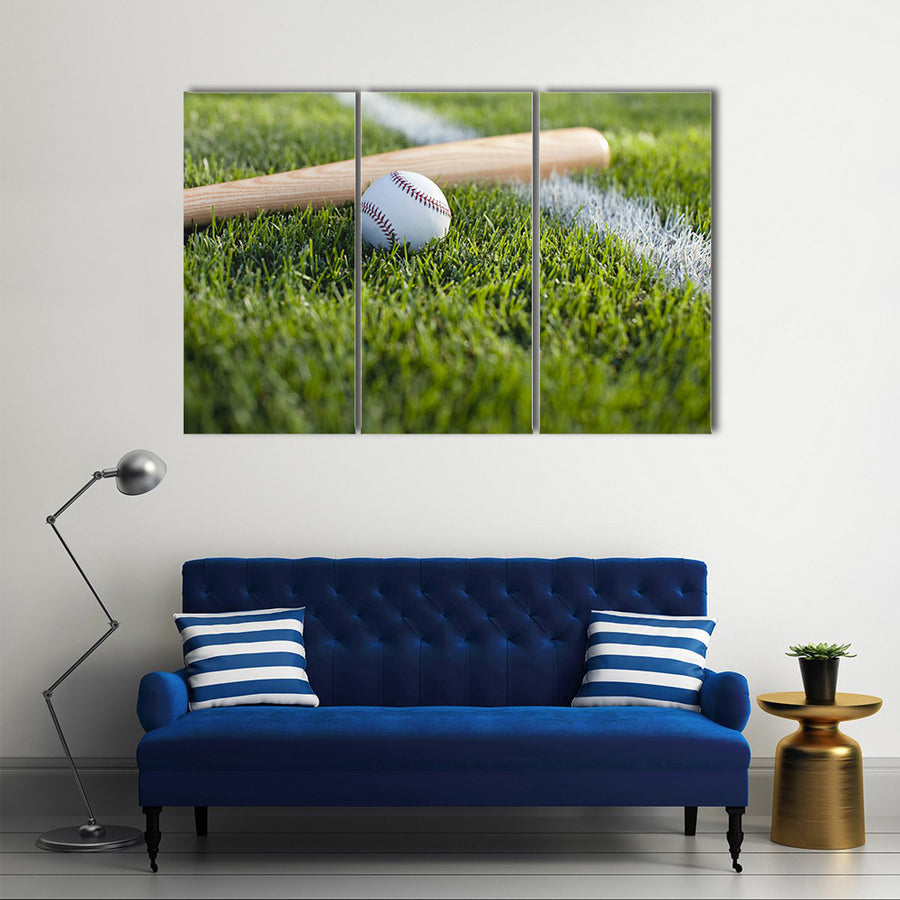 a baseball bat and ball on the grass near a field stripe Multi Panel Canvas Wall Art
