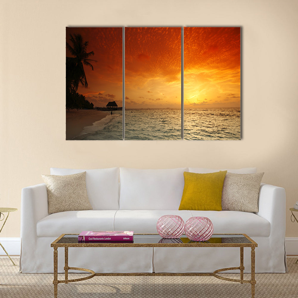 Beautiful view of sea and empty beach with palms on sunset Multi panel canvas wall art