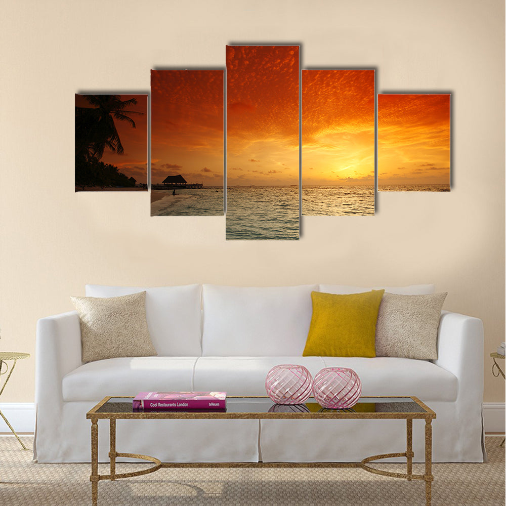 Beautiful view of sea and empty beach with palms on sunset Multi panel canvas wall art