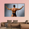 Young bodybuilder showing his biceps on a gray background Multi panel canvas wall art