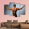 Young bodybuilder showing his biceps on a gray background Multi panel canvas wall art