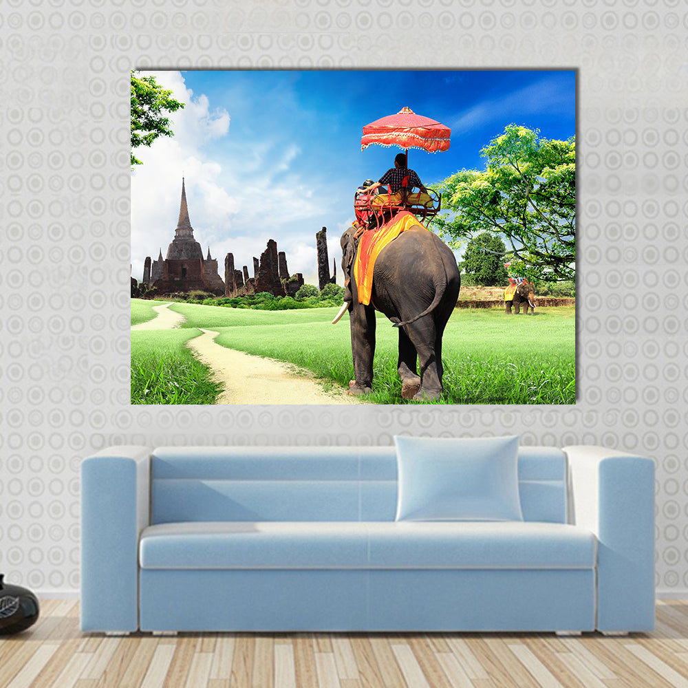 tourists on an elephant Multi panel canvas wall art