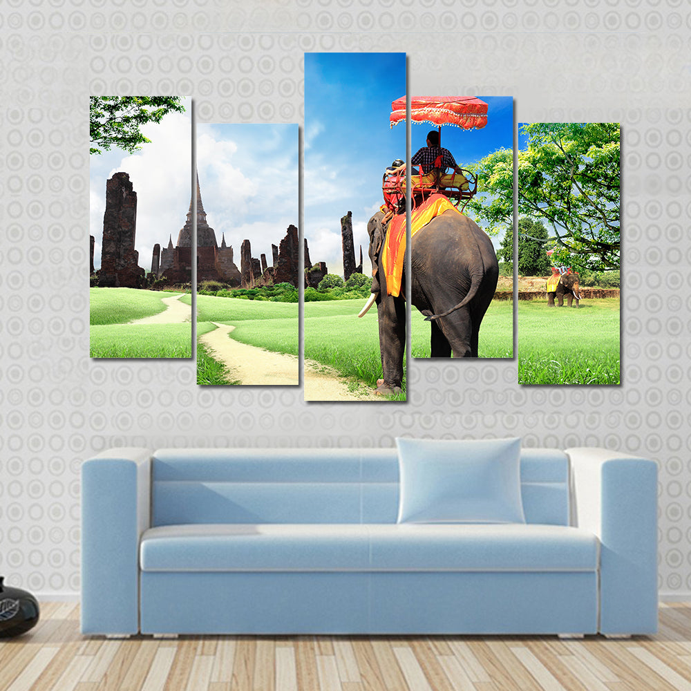 tourists on an elephant Multi panel canvas wall art