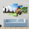 tourists on an elephant Multi panel canvas wall art