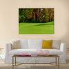 Golf course putting green with flag in autumn colors Multi Panel Canvas Wall Art