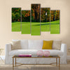 Golf course putting green with flag in autumn colors Multi Panel Canvas Wall Art